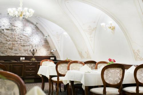 a dining room with a table and chairs at Arcadia Boutique Hotel in Bratislava