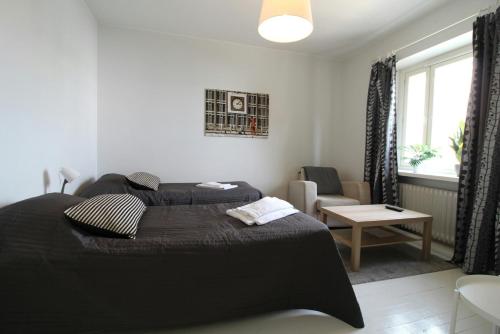 a bedroom with two beds and a living room at Central Studio for 2 in Kotka