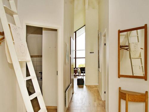 a hallway with stairs and a mirror on the wall at 6 person holiday home in Egernsund-By Traum in Egernsund