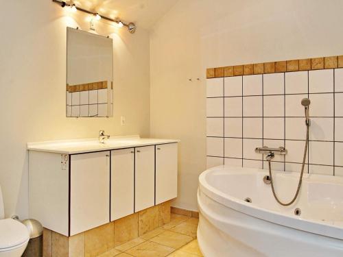 a bathroom with a tub and a sink and a toilet at 6 person holiday home in Egernsund-By Traum in Egernsund