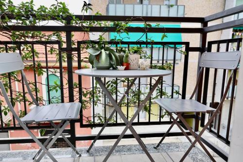 a table and two chairs on a balcony at Davide Host LH89, 30min Duomo in Sesto San Giovanni