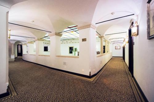 an empty hallway in a building with white walls and ceilings at Arcadia Boutique Hotel in Bratislava