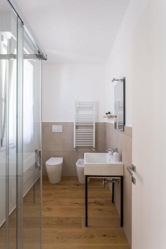 a bathroom with a sink and a toilet at Dimora Caprera - Appartamenti in Falconara Marittima