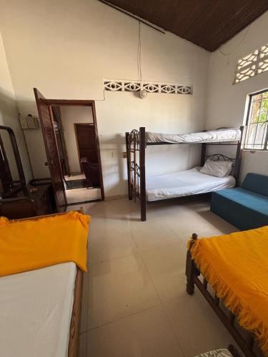 a room with two bunk beds and a mirror at Casa sol en el jardin - piscina y relajacion total in Carmen de Apicalá