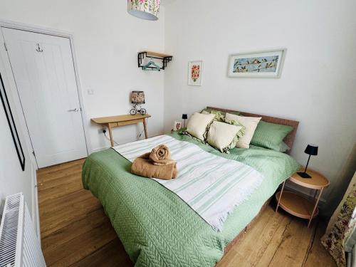 a bedroom with a large bed with a teddy bear on it at Luxury flat next to Blyth Port in Blythe