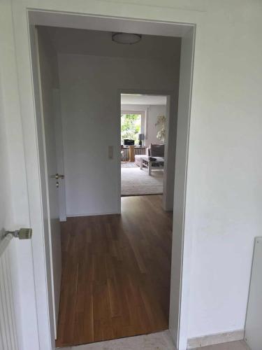 an empty room with a hallway leading to a living room at Ferienwohnung Kempten (Allgäu) in Kempten