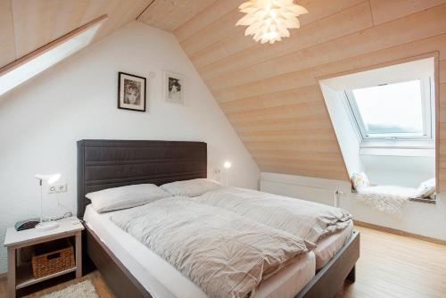 a bedroom with a large bed in a attic at Ferienwohnung Hinz in Todtnau