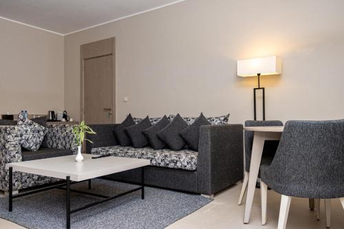 a living room with a couch and a table at Azalaï Hôtel Ouagadougou in Ouagadougou
