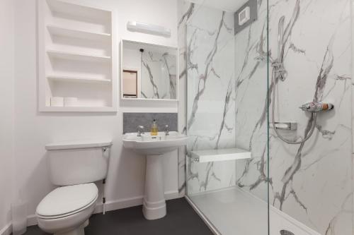 a bathroom with a toilet and a sink and a shower at Lawhead Road East in St. Andrews