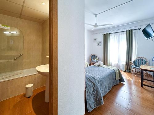 a bedroom with a bed and a bathroom with a sink at Pey Resort in Sort