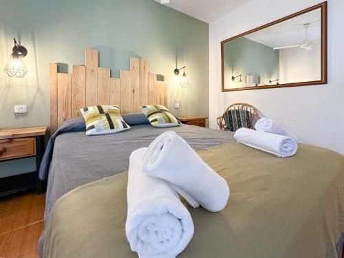 a bedroom with a large bed with towels on it at Pey Resort in Sort