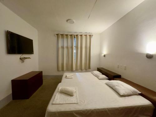 a bedroom with two twin beds and a television at Casa di Carpio in Iquitos