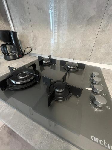 a black stove top with a coffee pot on it at Apartament Fantasy in Craiova