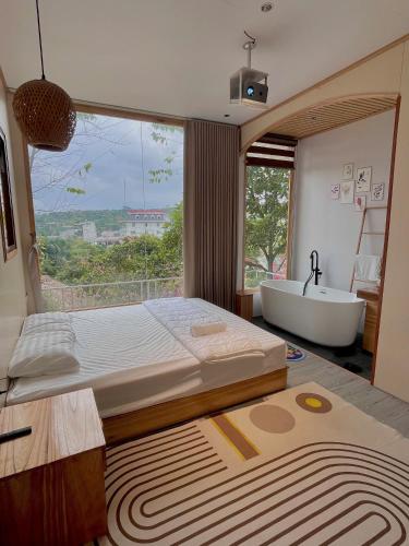a bedroom with a bed and a tub and a window at Flourish Homestay in Mộc Châu