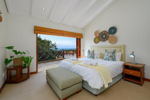 a bedroom with a large bed and a balcony at San Lameer Villa 11703 - 5 Bedroom Luxury - 10 pax - San Lameer Rental Agency in Southbroom