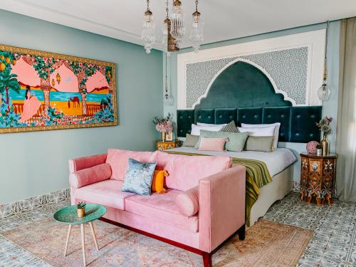 a bedroom with a pink couch and a bed at Nour Boutique Hotel in Dahab