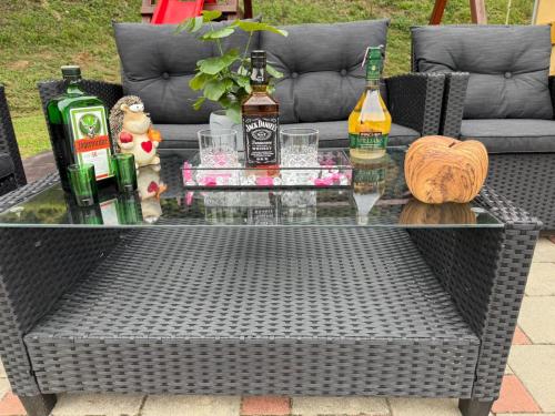 a coffee table with alcohol bottles on top of it at VILA LASOVIC + POOL + JACUZZI + SAUNA in Tuhelj