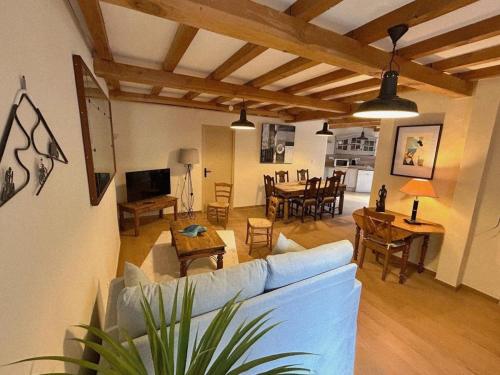 a living room with a blue couch and a table at Les Cols du Ventoux - Appartement La Madeleine in Bédoin