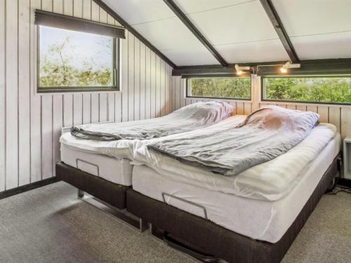 a bed in a room in a tiny house at Holiday Home Winter - 31km from the sea by Interhome in Toftlund