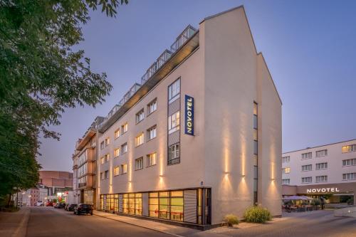 a building with a sign on the side of it at Novotel München City in Munich