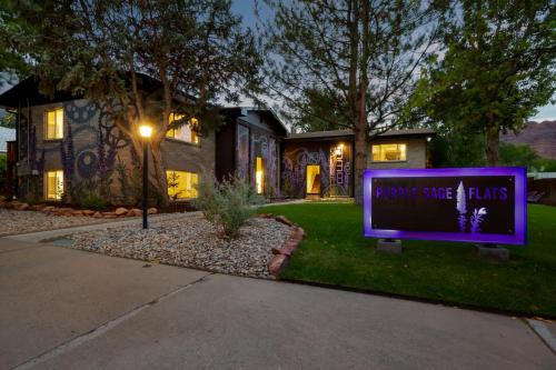 a house with a purple sign in the front yard at Downtown Cozy Home Base - Purple Sage 5 in Moab