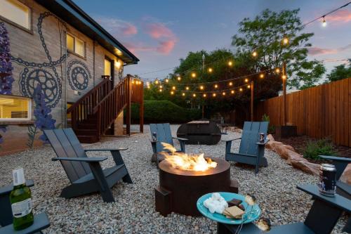 a backyard with chairs and a fire pit and a fence at Downtown Cozy Home Base - Purple Sage 5 in Moab