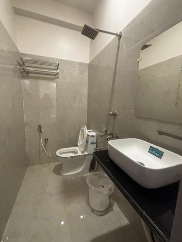 a bathroom with a sink and a toilet at GOLDEN VISTA RESORT - 10 Minute From Mayapur Temple in Krishnanagar