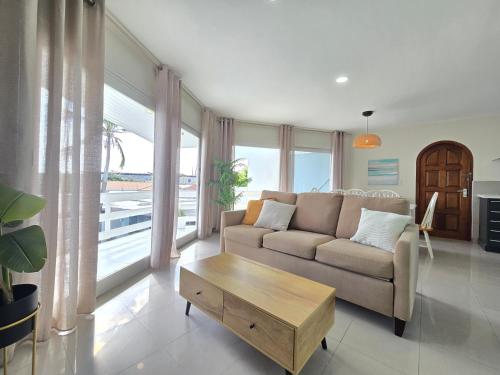 a living room with a couch and a coffee table at Bubali Residence in Palm-Eagle Beach