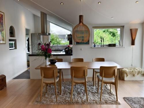 a kitchen and dining room with a table and chairs at Holiday Home Siegfried - 300m to the fjord by Interhome in Kirke-Hyllinge