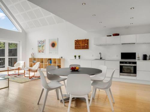 a kitchen and dining room with a table and chairs at Holiday Home Anelle - 2-5km from the sea by Interhome in Blokhus