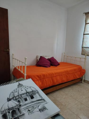 a bedroom with two beds and a drawing of a building at Depto Tucumán in San Miguel de Tucumán