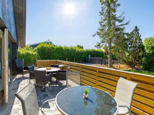 a patio with a table and chairs on a deck at Holiday Home Abel - 250m from the sea by Interhome in Strøby