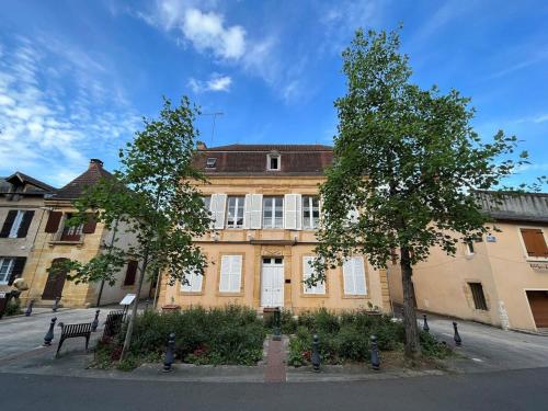 a large brick building with trees in front of it at Chaleureux studio - Centre ville in Paray-le-Monial