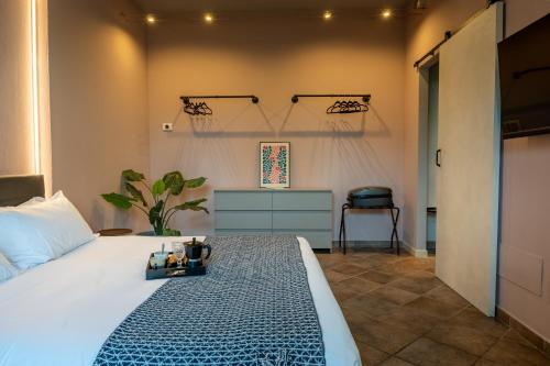 a bedroom with a bed with a tray of food on it at Da Gise Giardino Wifi Malpensa in Somma Lombardo