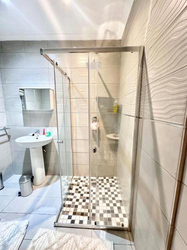 a bathroom with a shower and a sink at Apartment in Bellville - self-catering in Bellville
