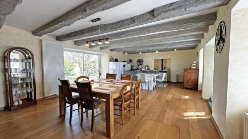 a kitchen and dining room with a table and chairs at Fayollas in Bussière-Galant