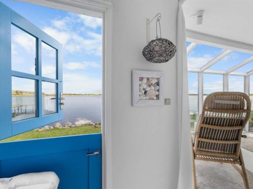 a door leading to a room with a view of the water at Holiday Home Jorek - 10m to the fjord by Interhome in Munkebo