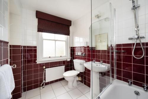 a bathroom with a toilet and a sink and a shower at The Open Arms Hotel in Dirleton