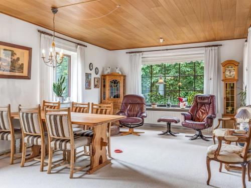 a dining room with a table and chairs at Holiday Home Hiarni - 12km from the sea by Interhome in Bredebro