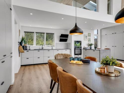 a kitchen and dining room with a table and chairs at Holiday Home Apelone - 900m from the sea by Interhome in Marielyst