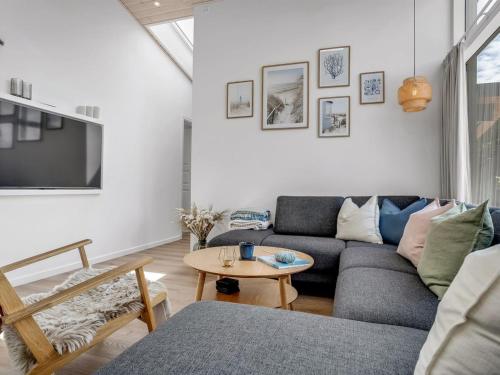 a living room with a couch and a table at Holiday Home Apelone - 900m from the sea by Interhome in Marielyst