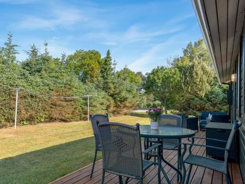 a patio with a table and chairs on a deck at Holiday Home Laris - 700m to the inlet by Interhome in Løgsted