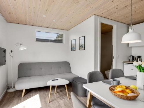 a living room with a couch and a table at Holiday Home Brun - 900m from the sea by Interhome in Marielyst