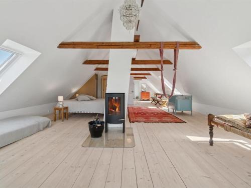 a living room with a fireplace and a bed at Holiday Home Aarni - 6-5km from the sea by Interhome in Gudhjem
