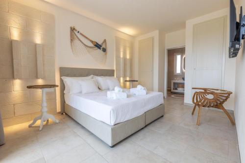 a bedroom with a bed and a table and a chair at Villa Regina Sul Mare in Torre Santa Sabina
