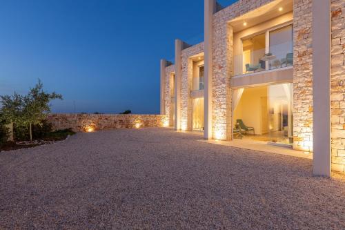 a driveway leading to a villa at night at Villa Regina Sul Mare in Torre Santa Sabina