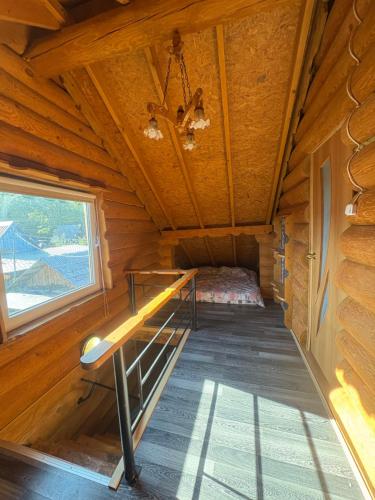 a room in a log cabin with a bed in it at Guest House Väikesaare in Narva