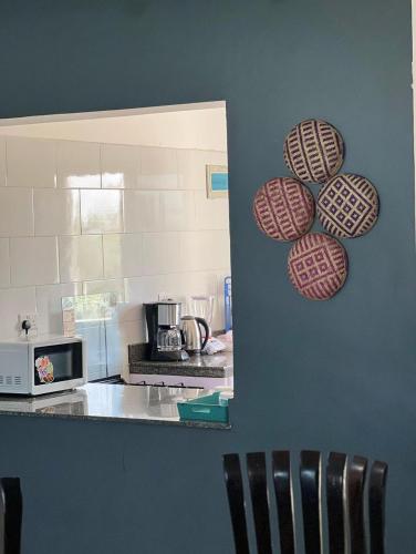 a kitchen with a counter and some plates on the wall at Kijani Suites in Nairobi
