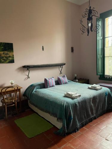 a bedroom with a bed with a green blanket at Casa Bellavista in Villa Lía