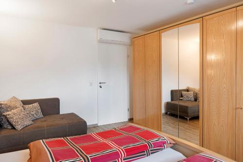 a living room with a couch and a chair at Ferienwohnung Eichenauer in Angersbach
